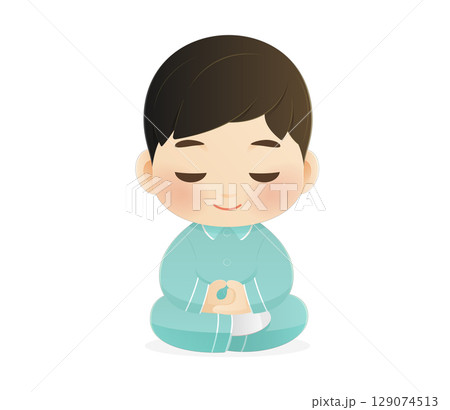 A cute boy meditates in pajamas before sleep. Calm and peaceful mood. 129074513