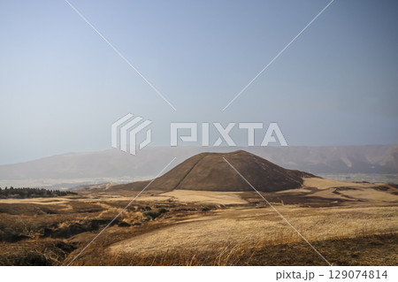 March 25 2025 Brown Hill in Vast Open Landscape with Mountains in the Distance, Japan 129074814