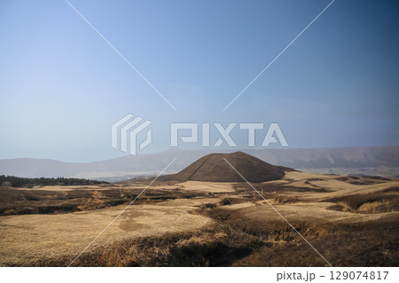 March 25 2025 Brown Hill in Vast Open Landscape with Mountains in the Distance, Japan 129074817