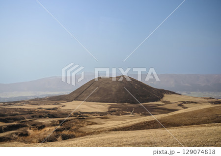 March 25 2025 Brown Hill in Vast Open Landscape with Mountains in the Distance, Japan 129074818