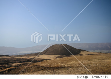 March 25 2025 Brown Hill in Vast Open Landscape with Mountains in the Distance, Japan 129074819