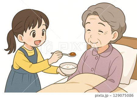 おばあちゃんに食事の世話をする女の子 129075086