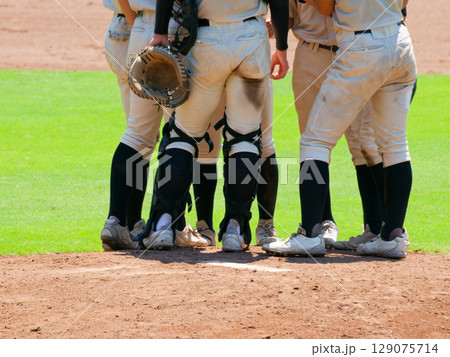 高校野球の試合中、マウンドに集まる野手たち 129075714