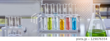 Banner Science chemistry glass tubes object on lab background. Wide Liquid tube biology laboratory chemical fluid scientist object medical glass tubes. Chemistry scientific background with Copy Space Banner Science chemistry glass tubes object on lab background. Wide Liquid tube biology laboratory chemical fluid scientist object medical glass tubes. Chemistry scientific background with Copy Space 129076354