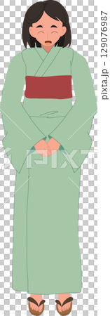 A young Japanese woman wearing a green yukata bows respectfully. 129076987