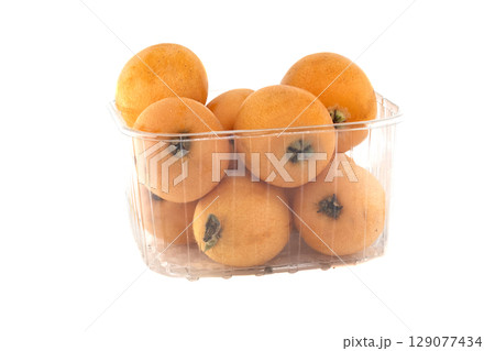 A container filled with delicious, ripe loquats, ready to be served for a healthy meal. 129077434