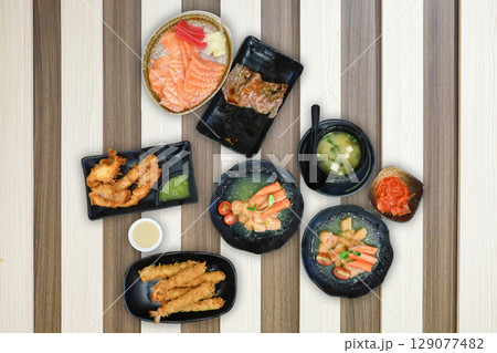 Top view of sushi, beef, and salmon fresh mixed, focus selective Top view of sushi, beef, and salmon fresh mixed, focus selective 129077482