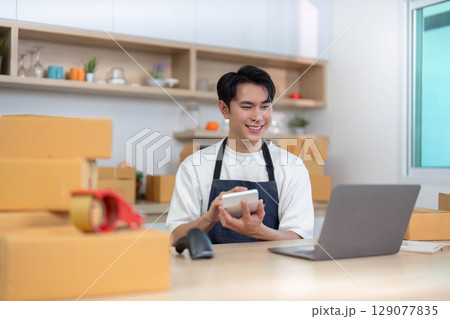 E-commerce entrepreneur packaging products in a bright workspace E-commerce entrepreneur packaging products in a bright workspace 129077835
