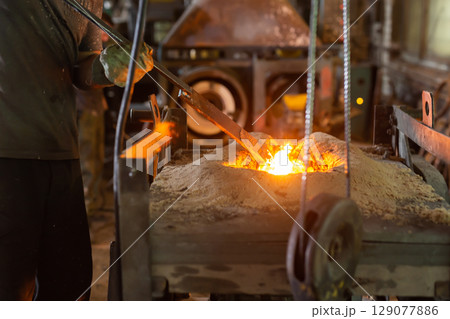 Ferrous metal billet is melted in an induction furnace closeup 129077886