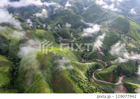 Landscape of Morning Mist with Mountain Layer. mountain ridge and clouds in rural jungle bush forest 129077942
