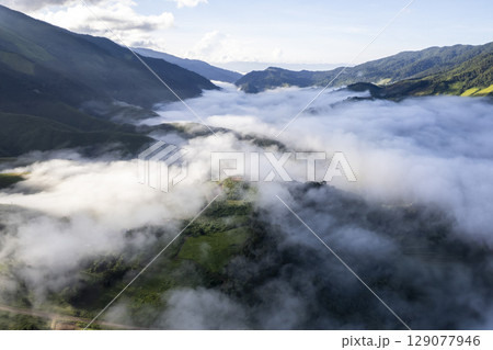 Landscape of Morning Mist with Mountain Layer. mountain ridge and clouds in rural jungle bush forest 129077946