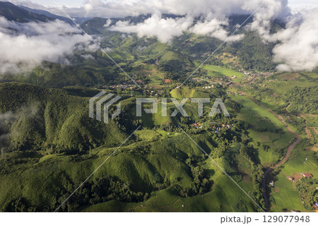 Landscape of Morning Mist with Mountain Layer. mountain ridge and clouds in rural jungle bush forest 129077948