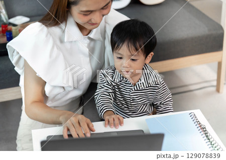 Engaged Mother and Son Exploring Digital Learning Together Engaged Mother and Son Exploring Digital Learning Together 129078839