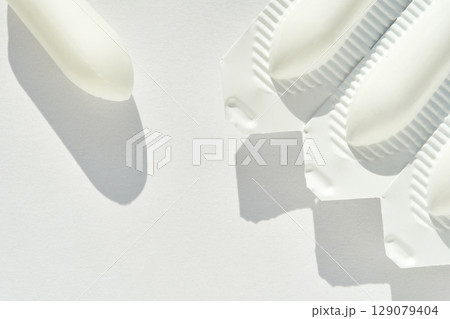 Medical suppository package flat lay on white background with shadows 129079404