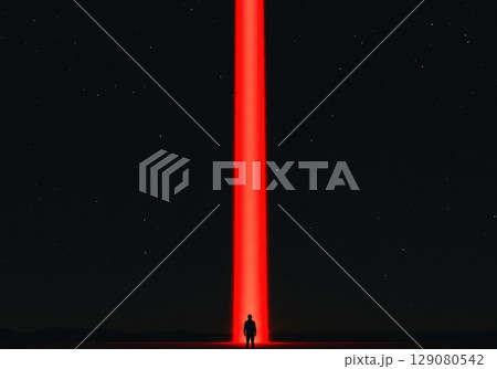 Mysterious silhouette against dramatic red light beam under starry night sky Mysterious silhouette against dramatic red light beam under starry night sky 129080542