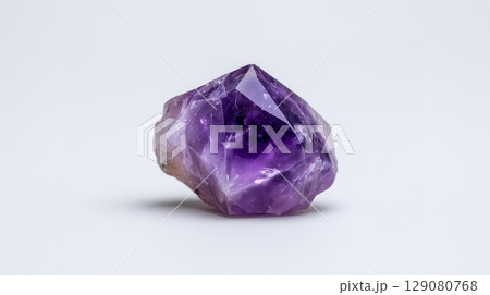 A beautiful unpolished purple gemstone or jewel on a white background A beautiful unpolished purple gemstone or jewel on a white background 129080768