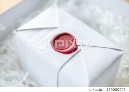 Wax seal stamp on white paper wrap packaging parcel box 129080993