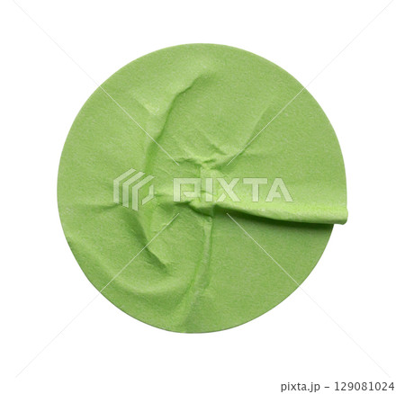 Blank green round adhesive paper sticker label isolated on white background 129081024