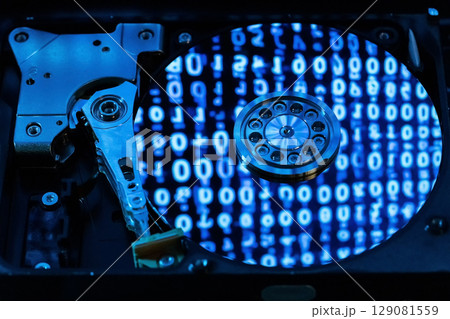 A hard disk with a blue binary code A hard disk with a blue binary code 129081559