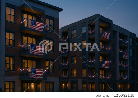 Apartment buildings adorned with festive decorations and American flags for Independence Day celebration Apartment buildings adorned with festive decorations and American flags for Independence Day celebration 129082119