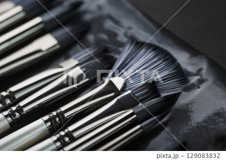 A set of art brushes for drawing on a black background 129083832