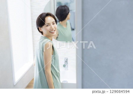 スキンケアをする洗面所の女性 129084594