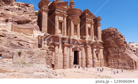 The Monastery monument. People in front of the rose-coloured monument of Ad-Dayr a Nabataean religious site carved into a sandstone cliff in Jordan's ancient city of Petra. The Monastery monument. People in front of the rose-coloured monument of Ad-Dayr a Nabataean religious site carved into a sandstone cliff in Jordan's ancient city of Petra. 129086064