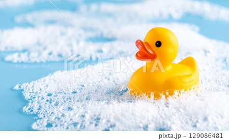 Yellow rubber duck floating in a baby's bathwater, a fun toy for children's playtime 129086481