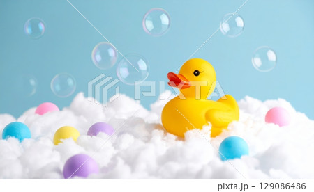 Yellow rubber duck toy floating in a child's bathwater 129086486