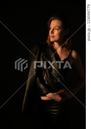 Slim woman in black leather suit and black lingerie 129086779