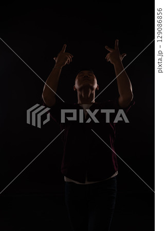 man in burgundy shirt dancing to music 129086856