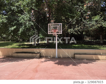 Urban park basketball court under sunny skies 129087815