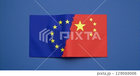 Globe split in China & EU flag symbolizes economic ties, competition in globalization and contrasts cooperation and rivalry 129088006