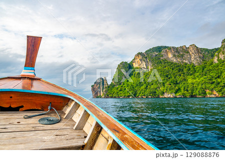 View of limestone rock at Ko Phi Phi islands, Thailand. View from long tailed boat. Exotic and tropic nature, summer paradise. View of limestone rock at Ko Phi Phi islands, Thailand. View from long tailed boat. Exotic and tropic nature, summer paradise. 129088876