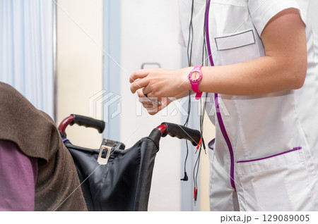 Nurse working with senior woman patient on wheelchair, clinics specialist at work, rehabilitation 129089005