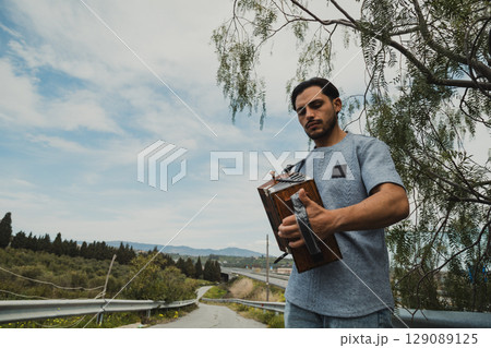 Man In The Countryside Feeling And Enjoying The Accordion Music  129089125