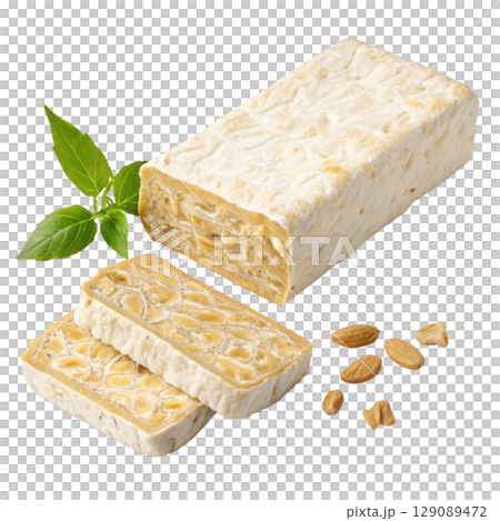 block of raw tempeh with firm texture is displayed alongside sliced pieces, soybeans, and green leaf, emphasizing its natural and healthy appeal 129089472