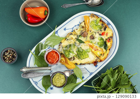 Omelet with broccoli and pepper. 129090133