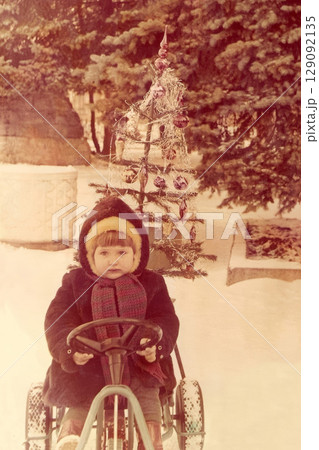 Soviet girl in a fur coat and a fur hat at a christmas Soviet girl in a fur coat and a fur hat at a christmas 129092135