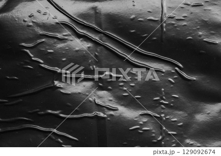 transparent plastic bag wrap overlay texture on black background transparent plastic bag wrap overlay texture on black background 129092674