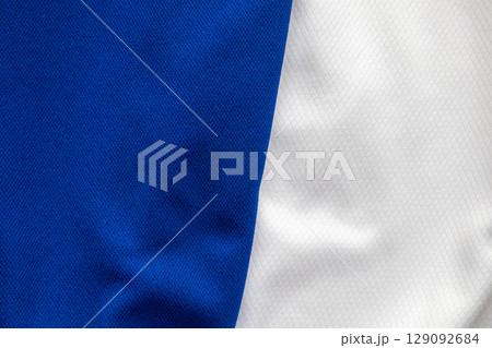 Blue and white sports clothing fabric football shirt jersey texture background Blue and white sports clothing fabric football shirt jersey texture background 129092684