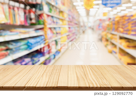 Empty wood table top with spet food shop blurred background 129092770