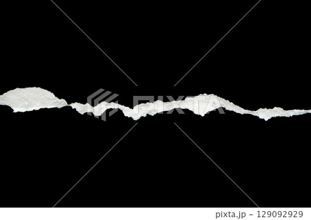 Ripped torn paper edges isolated on black background Ripped torn paper edges isolated on black background 129092929