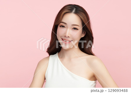 A beautiful young Asian woman with clean, fresh skin against a pink background. Skincare, facial treatment, cosmetology, beauty, and spa. An elegant portrait of an Asian woman. A beautiful young Asian woman with clean, fresh skin against a pink background. Skincare, facial treatment, cosmetology, beauty, and spa. An elegant portrait of an Asian woman. 129093488