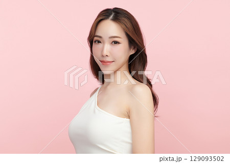 A beautiful young Asian woman with clean, fresh skin against a pink background. Skincare, facial treatment, cosmetology, beauty, and spa. An elegant portrait of an Asian woman. A beautiful young Asian woman with clean, fresh skin against a pink background. Skincare, facial treatment, cosmetology, beauty, and spa. An elegant portrait of an Asian woman. 129093502