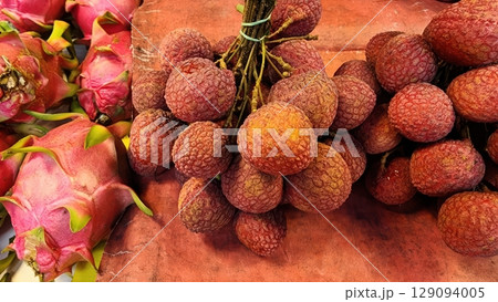 Fresh Lychee Fruit and Dragon Fruit at a Market Fresh Lychee Fruit and Dragon Fruit at a Market 129094005