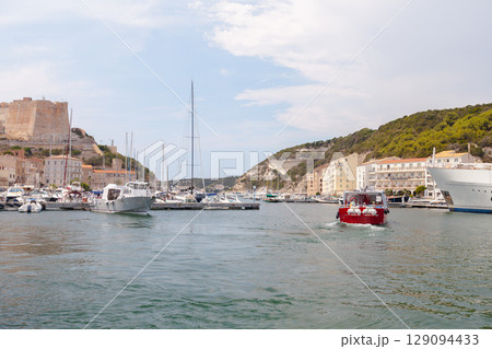 Scenic Harbor View With Boats and Hillside Buildings Under a Clear Sky 129094433