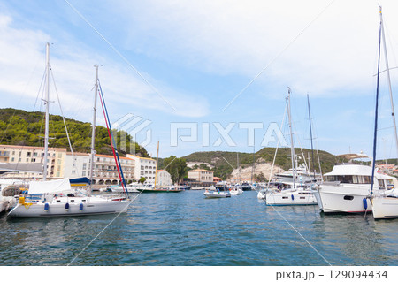 Picturesque Marina with Docked Sailboats and Hills in the Background Picturesque Marina with Docked Sailboats and Hills in the Background 129094434