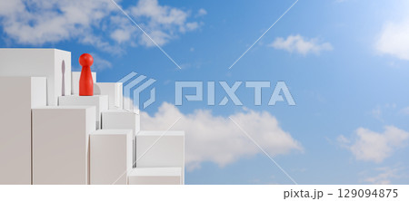 Red doll stands atop a white staircase reaching into a blue sky with clouds, symbolizing leadership, success, goal achievement, ambition, and overcoming challenges. 129094875