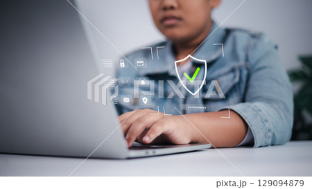 Cyber security concept showing Asian boy using laptop with digital interface, symbolizing online safety, data privacy, and child internet protection. Cyber security concept showing Asian boy using laptop with digital interface, symbolizing online safety, data privacy, and child internet protection. 129094879